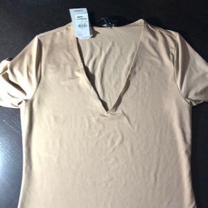 Body contour shirt size small. New with tags but has deodorant marks